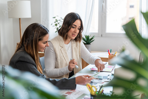 Businesswomen Analyzing Documents Together