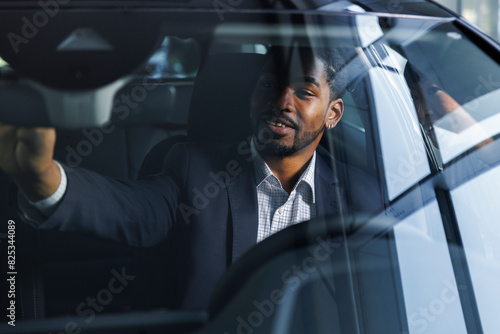 Driver getting comfortable while starting a test drive photo