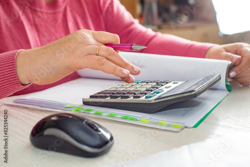 Accountant counts on a calculator photo