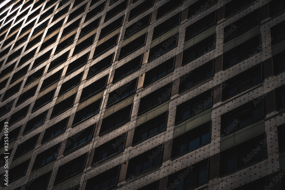 Close-up of a fragment of a multi-storey high-rise residential building. apartments and office space. Background for a banner for the sale and rent of real estate. Close-up of a fragment of a multi-storey high-rise residential building. apartments and office space. Background for a banner for the sale and rent of real estate.