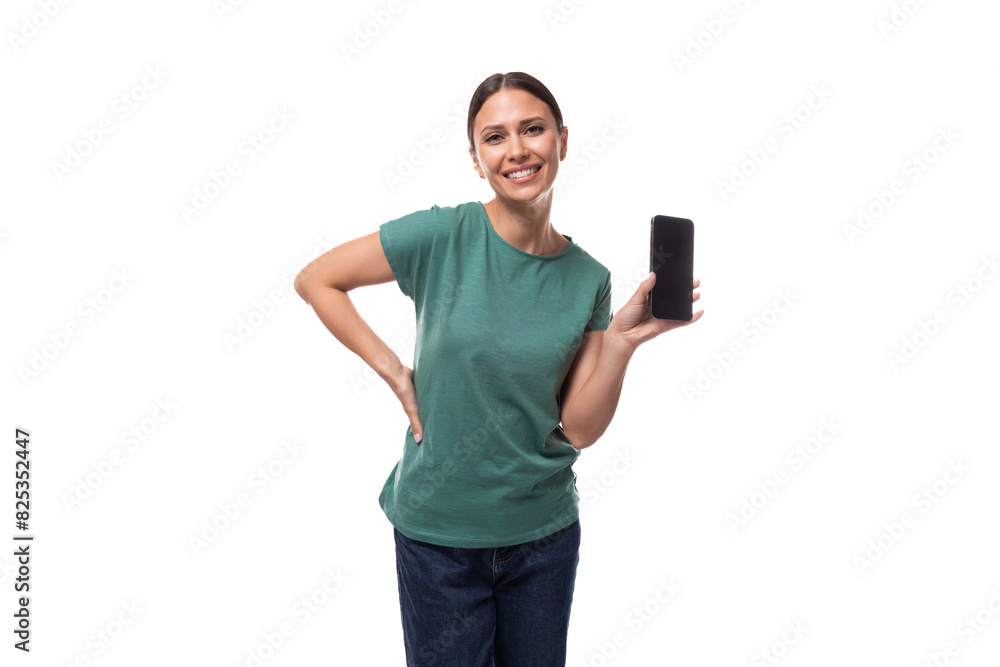 young black-haired woman dressed in a basic t-shirt holding a smartphone young black-haired woman dressed in a basic t-shirt holding a smartphone