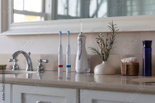 Electric Toothbrush next to sink  still life water flosser still life photo