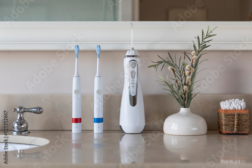 Electric Toothbrush next to sink  still life water flosser  photo