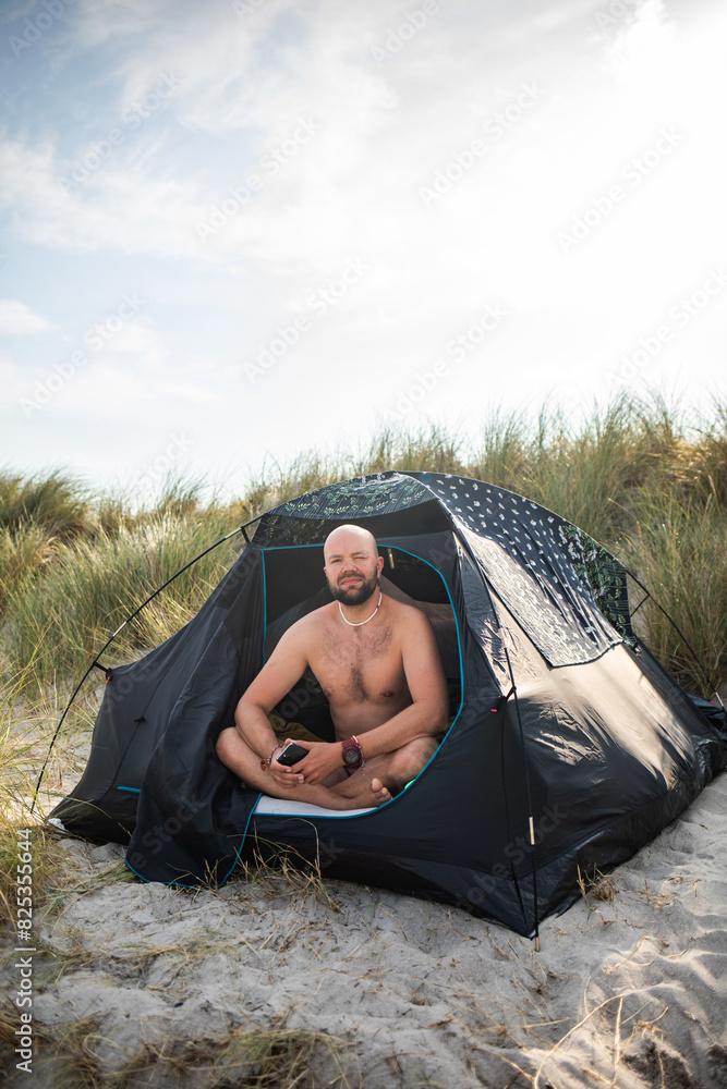 Man Relaxing in Tent by the Dunes Man Relaxing in Tent by the Dunes