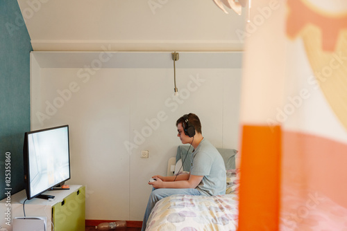 Teenage room with a person playing video games photo