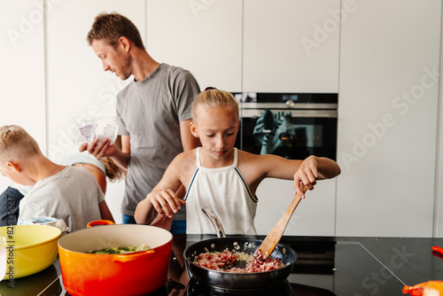 Family cooking together in modern kitchen