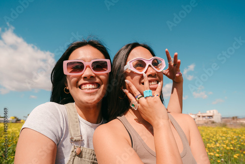 Carefree portrait of Gen Z asian women with sunglasses photo