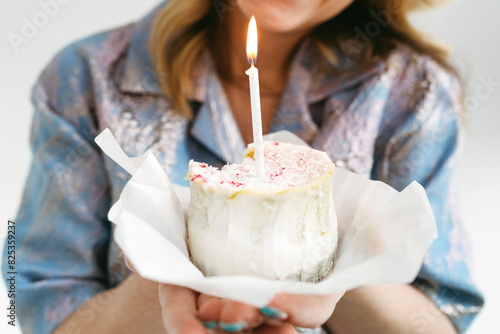 Crop Woman Holding Birthday Cupcake With Lit Candle photo