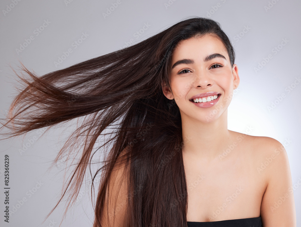 Obraz premium Studio, wind and portrait of woman with hair care for shampoo growth, treatment and healthy texture. Smile, female person and confidence on white background for hairstyle, satisfaction and pride