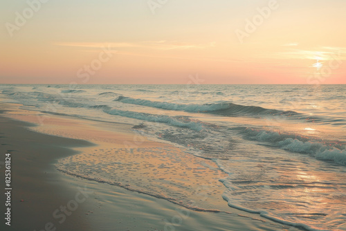 The ocean is calm and the sky is a beautiful orange color