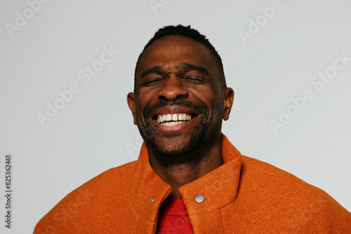 Fashionable man laughing in studio photo