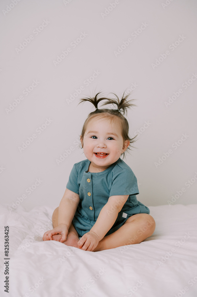 smiling one year old baby girl in blue dress smiling one year old baby girl in blue dress