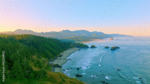 Aerial Sunrise Tracking Shot Over Ecola Park and Crescent Beach photo