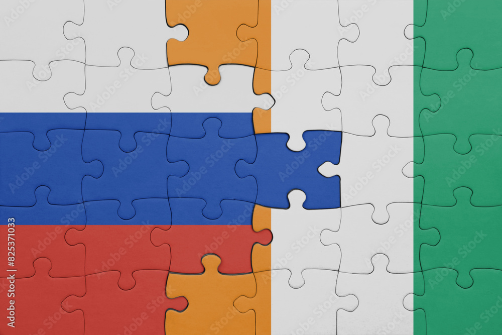 puzzle with the colourful national flag of cote divoire and flag of russia. puzzle with the colourful national flag of cote divoire and flag of russia.
