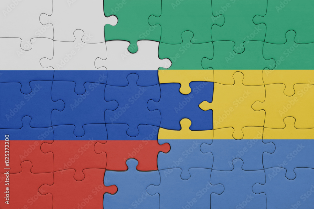 puzzle with the colourful national flag of gabon and flag of russia. puzzle with the colourful national flag of gabon and flag of russia.