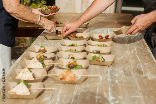 catering company serving trays of food at an event photo