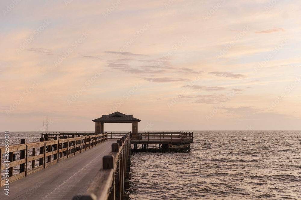 Pier at Fairhope, AL stretching into the ocean during sunset