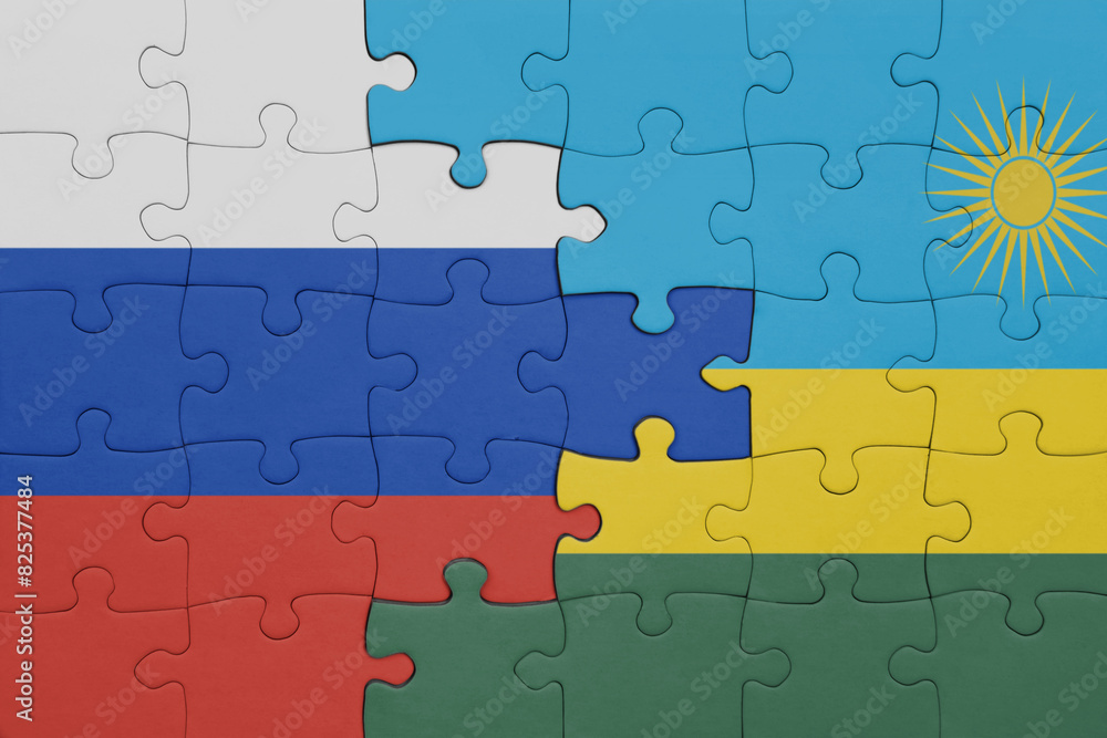 puzzle with the colourful national flag of rwanda and flag of russia. puzzle with the colourful national flag of rwanda and flag of russia.