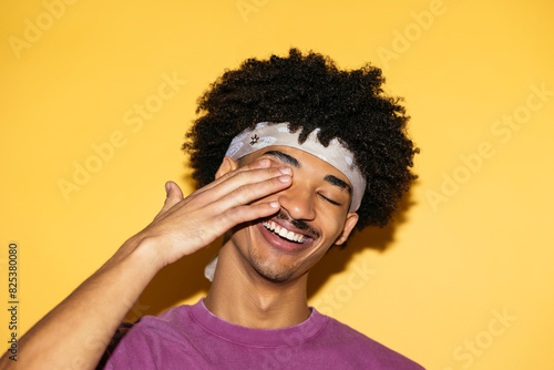 Fashionable man in yellow background photo