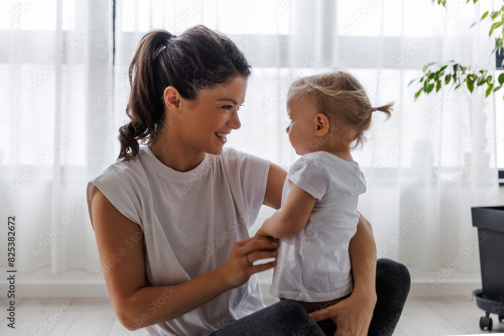Happy mother playing with daughter at home Happy mother playing with daughter at home