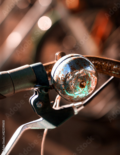 Close-up of a bicycle bell with a soft focus background