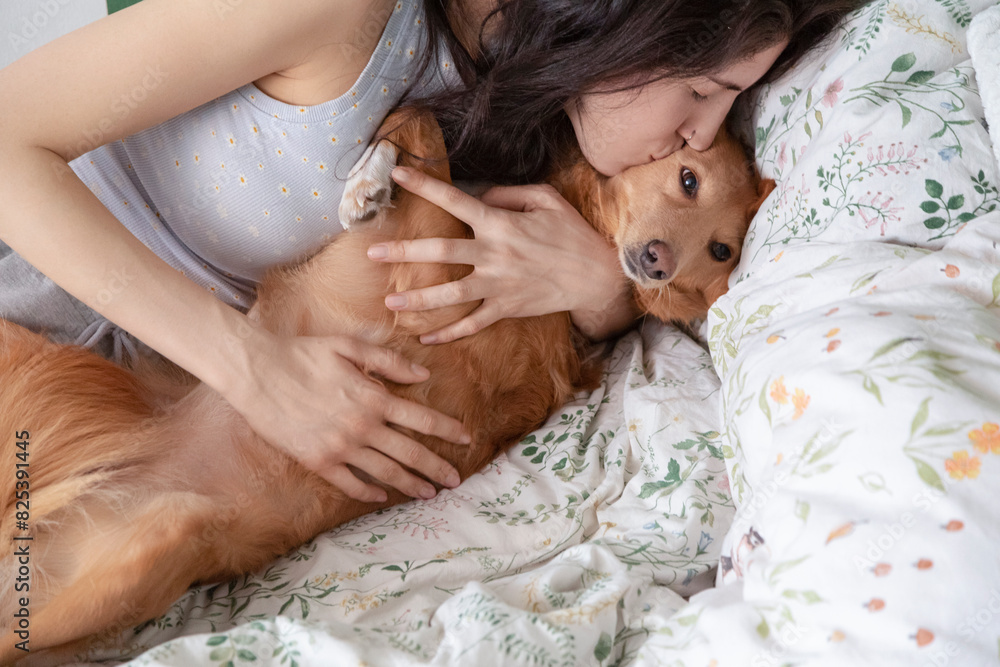 Woman Embracing Ginger Dog on Bed Woman Embracing Ginger Dog on Bed