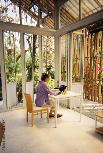 UGC of young woman working on netbook in home office photo