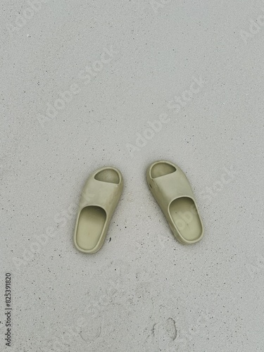 Close up of green slippers on the beach photo