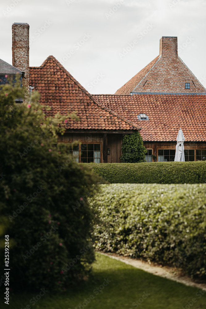 Traditional brick house with lush garden Traditional brick house with lush garden
