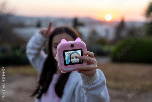 Sunset Selfie With Playful Instant Kids Camera. photo