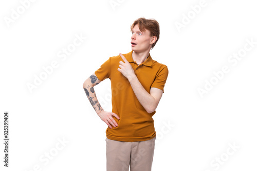 surprised red-haired guy dressed in an orange t-shirt on a white background