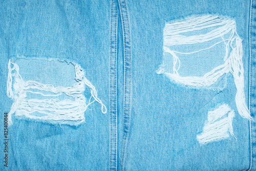 Close-up of classic blue denim jeans with ripped details with flash photo