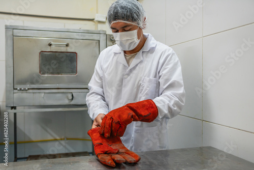 Factory Worker Putting on Gloves photo