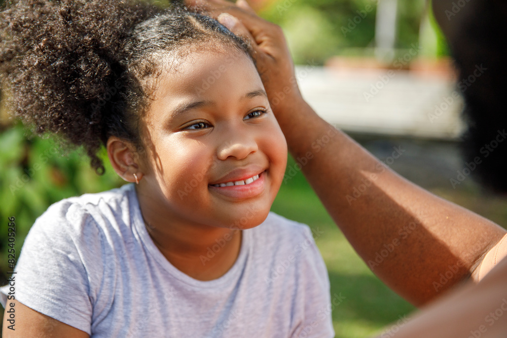 Cute smiling girl looking at father in park Cute smiling girl looking at father in park