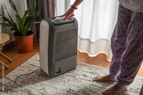 turning on air purifier at home photo