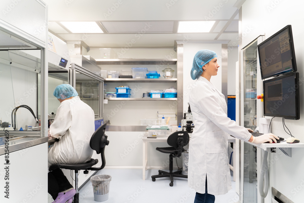 Scientists Working In Optical Coatings Laboratory Scientists Working In Optical Coatings Laboratory