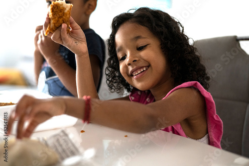 Toddler eating fired chicken photo