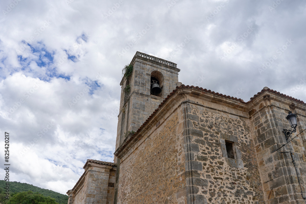 A large stone building with a bell tower. Church of Our Lady of the Assumption. Canales de la S