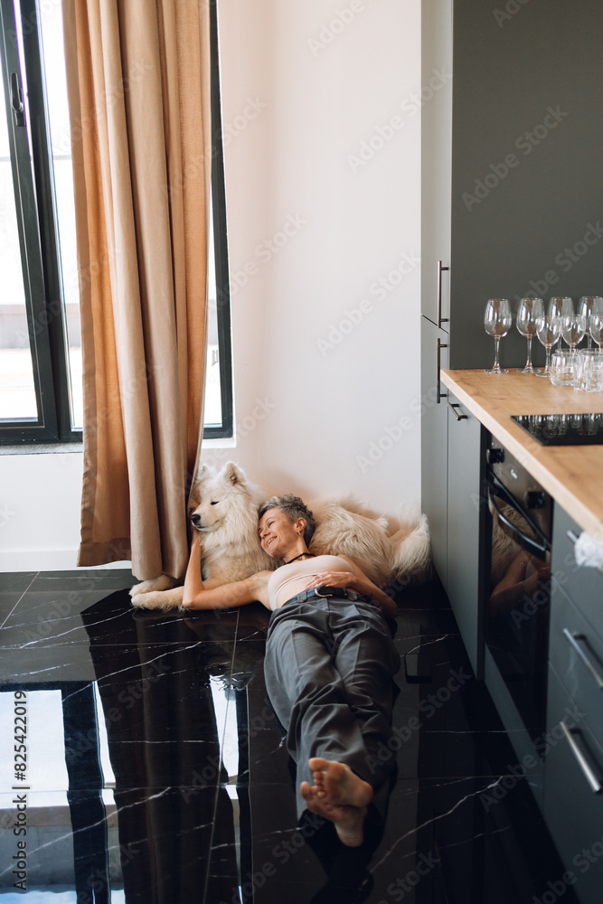 A woman with a dog indoors A woman with a dog indoors