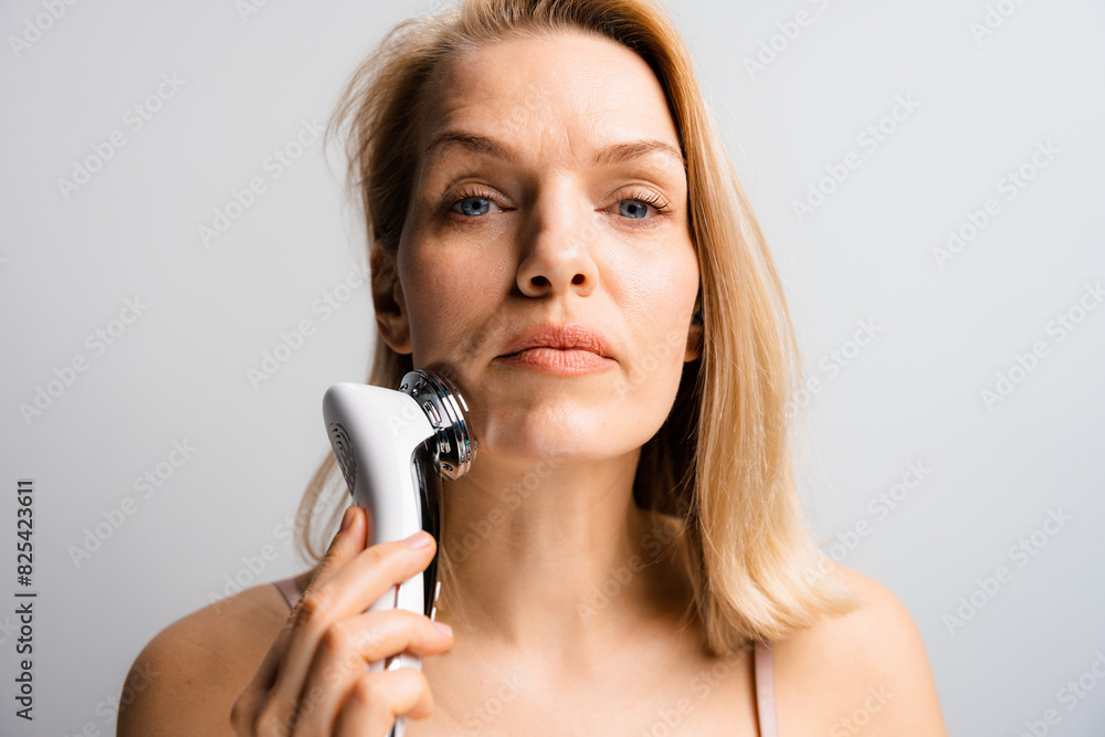 A woman does a facial massage A woman does a facial massage