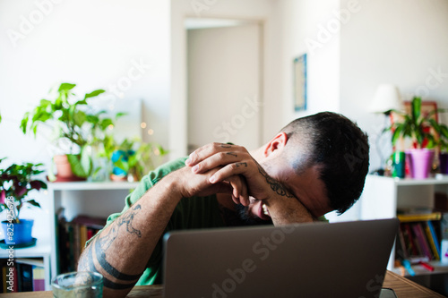 LGBTQ man loughing hard at home photo