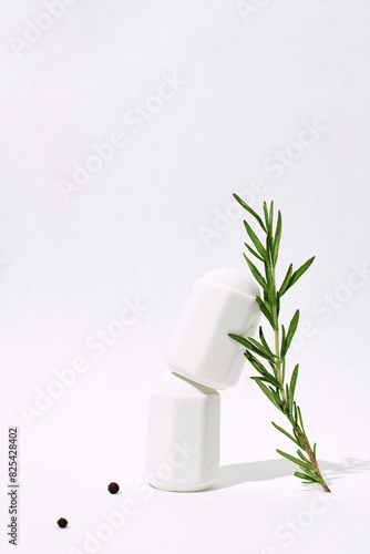 Balanced spoon on salt shakers with herbs photo