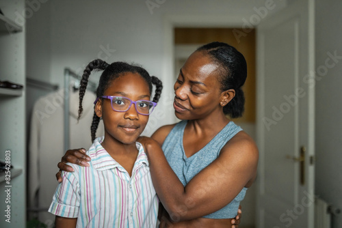 portrait of young mother with her daughter at home photo