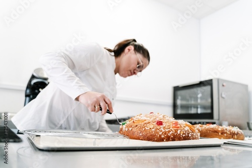 Pastry chef decorating artisan cake in kitchen photo