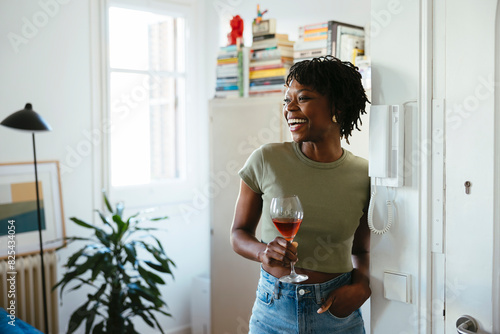 Cheerful woman with glass of wine photo