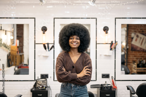 hairdresser talking to client after cutting and styling afro hair photo