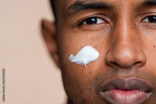 Close-up of man with moisturizer on face photo