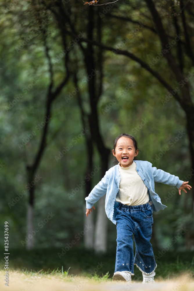 happy little asian girl running in the spring park happy little asian girl running in the spring park