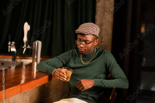 Portrait of stylish man spending time alone at the bar 