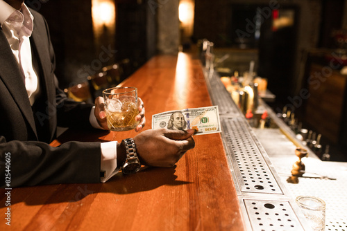 A wealthy man in a bar photo